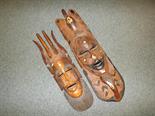 Two wooden carved tribal masks with inlaid detail