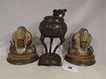 An incense burner with tripod stand decorated with a Foo dog finial and relief decoration and a pair