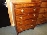 An early 20th century mahogany chest of two over three graduated drawers with brass drop handles