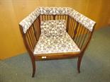 An early 20th century nursing chair with spindle back and sides, soft upholstered to the back and