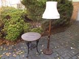 A circular topped wrought iron pub table of typical form and a wooden standard lamp and shade ca