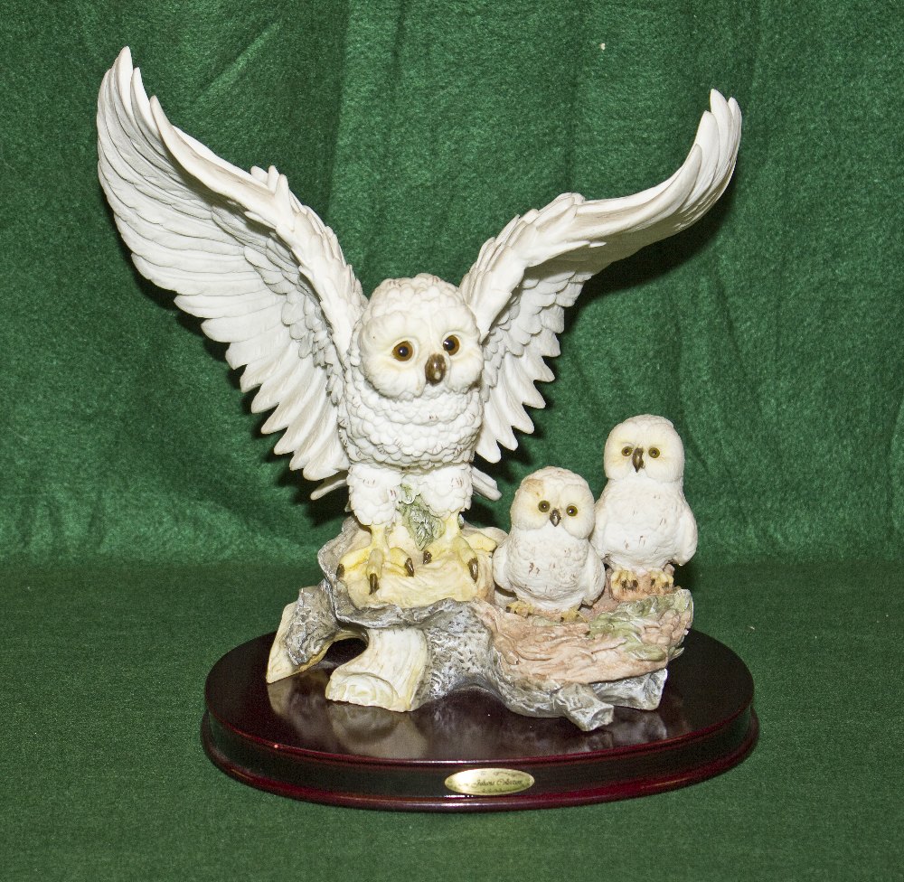 A Juliana Collection figure group of a snowy owl and chicks. 24.cm high