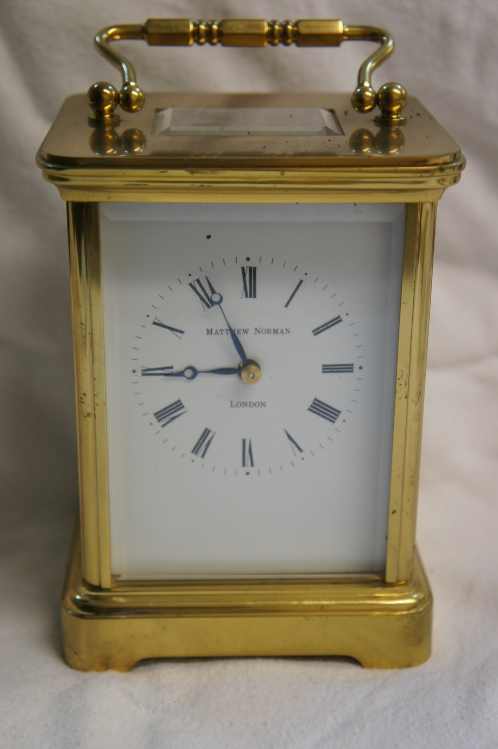 Matthew Norman London, four glass brass carriage clock with white