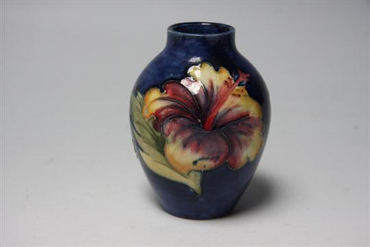 A Small Moorcroft Hibiscus Vase On Blue Background In Gloss