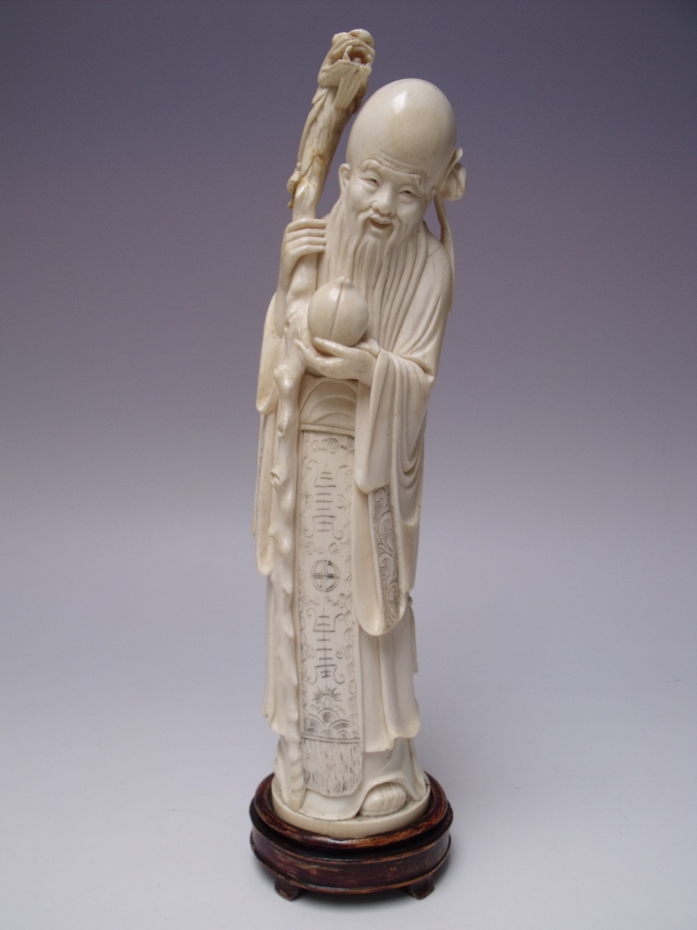 A LARGE CHINESE IVORY STATUE DEPICTING SHOU XING THE GOD OF LONGEVITY