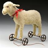 1920s ERA STEIFF LAMB ON WHEELS WITH BUTTON. A sweet and well designed and manufactured barnyard