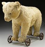 EARLY WHITE CENTER SEAMED STEIFF BEAR WITH BUTTON ON METAL WHEELS. This bear is made from white