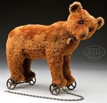 EARLY CINNAMON BROWN CENTER SEAMED STEIFF BEAR ON WHEELS. Bear is standing, firmly stuffed with