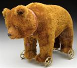 CIRCA 1919 BROWN MOHAIR BING BEAR ON WHEELS WITH MARK. Teddy is standing on all fours and