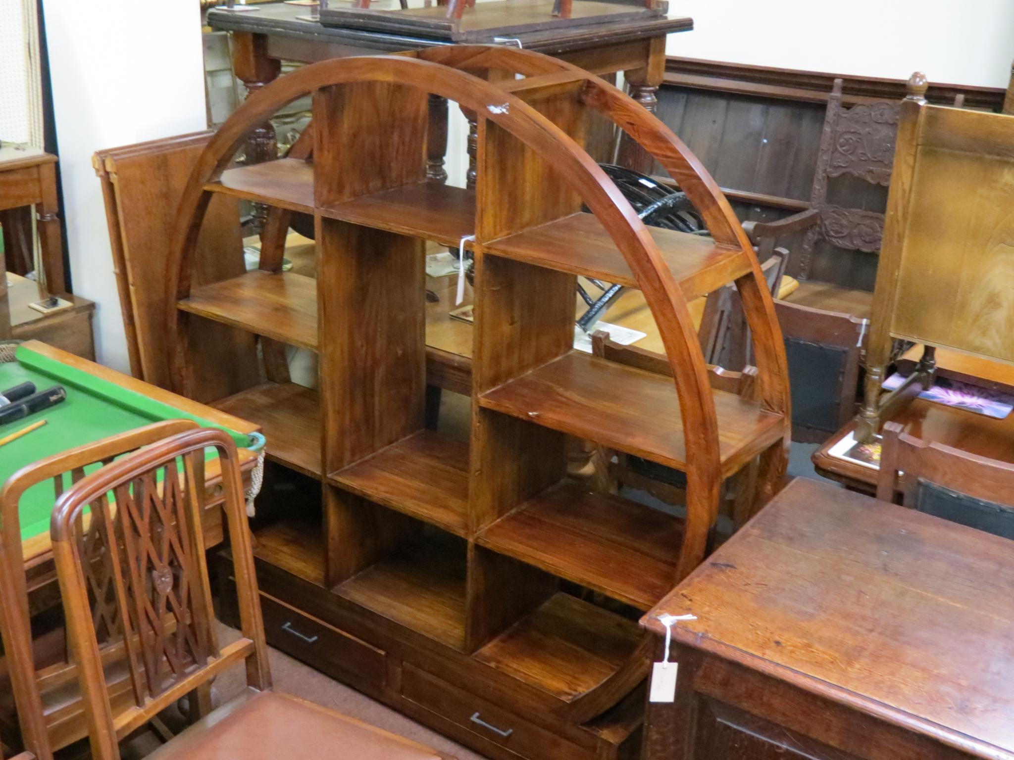 An Art Decostyle circular display unit, fitted with eight open shelves