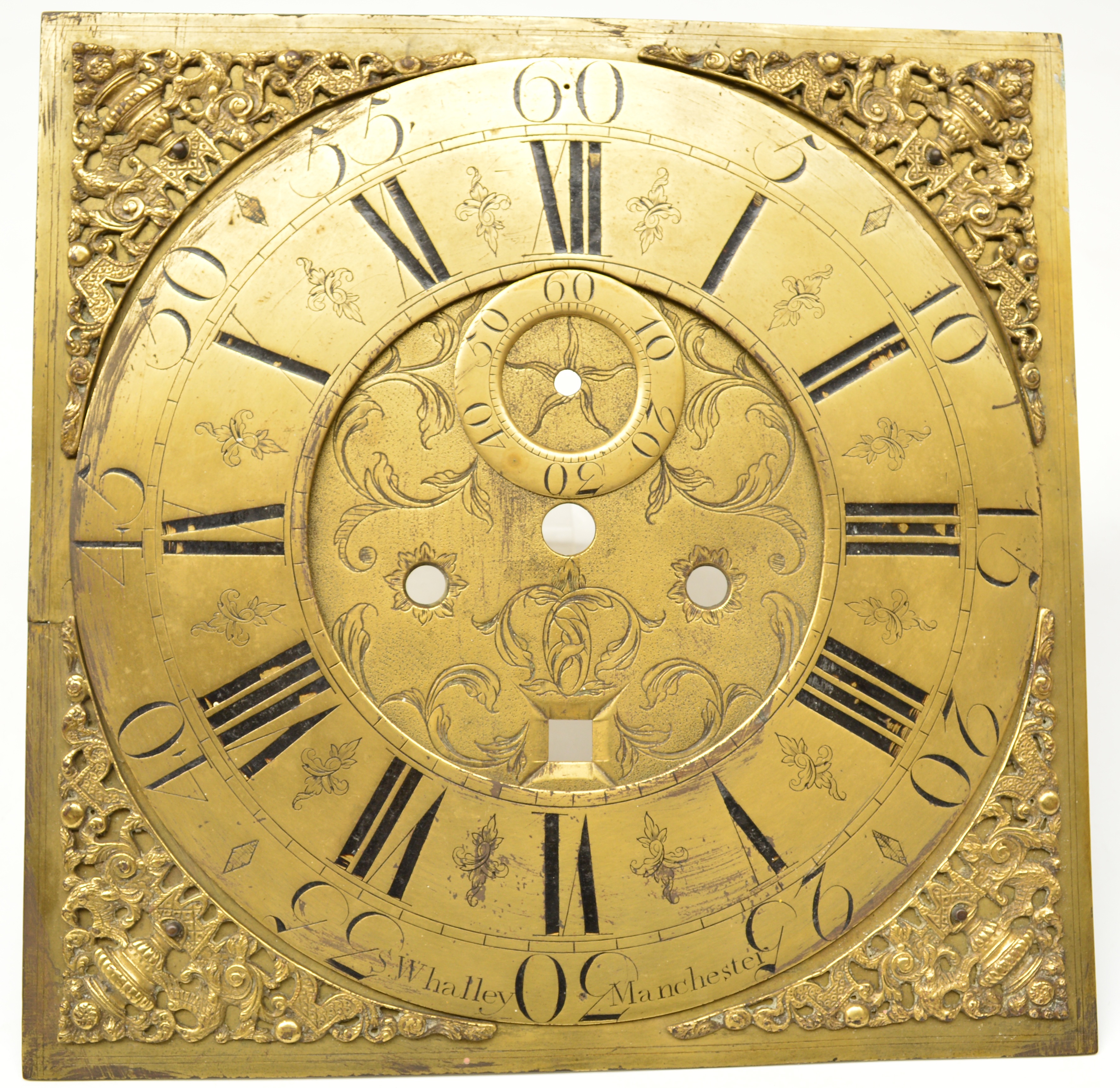 A brass square clock face by S. Whalley, Manchester with Roman numerals