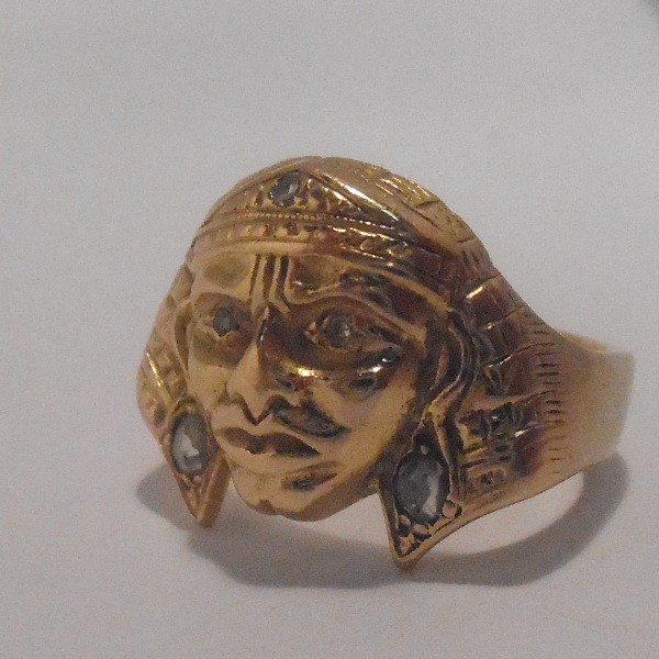 A rose diamond mounted Egyptianesque mask ring stamped `18ct`.