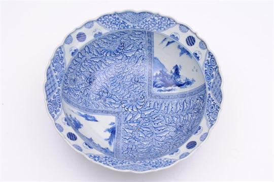 A large Arita bowl with everted barbed rim, the interior painted in underglaze blue with lake and