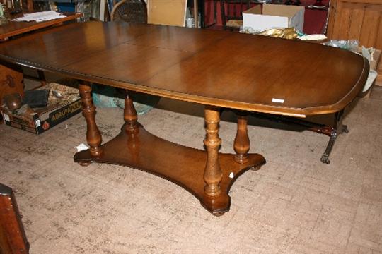 An Oak Effect Stag Madrigal Dining Table On Four Turned Column