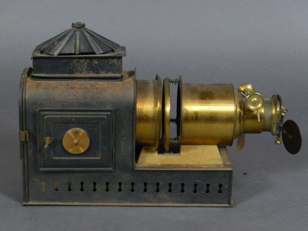 A Victorian tinplate and brass magic lantern slide projector, wired for