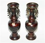 A pair of Japanese bronze vases, circa 1900, each of baluster form with two handles under a flared