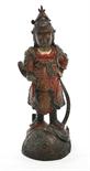 AN EARLY PAINTED CHINESE BRONZE FIGURE OF A GUARDIAN,
painted in various colours, standing on a