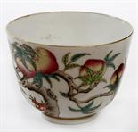 A CHINESE PORCELAIN BOWL , 
decorated with peach trees, fruit, and flying bats, on a white ground,