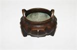 A HEAVY CHINESE BRONZE CENSER, 
with two handles and fluted body, raised on three legs, four