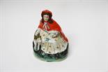 A STAFFORDSHIRE GROUP,
19th century, modelled as Red Riding Hood with fox, 11.25in (29cm). (1).