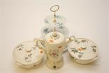 THREE SIMILAR CERAMIC CASSEROLE DISHES, 
each with two handles and a cover; a Wedgwood water jug,