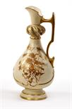 A ROYAL WORCESTER EWER,
late 19th century, of baluster form, the cream ground with gilt floral