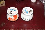 A PAIR OF CHINESE PORCELAIN OGEE SHAPED BRUSH POTS AND COVERS, 
each decorated with temple lions, in