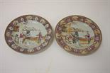 A PAIR OF LATE 18TH CENTURY FAMILLE ROSE PLATES, 
each decorated with figures on a balcony by a