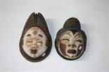 A CARVED AFRICAN “DUG OUT”
TRIBAL FEMALE MASK, polychrome
painted with eye slits and pale face,