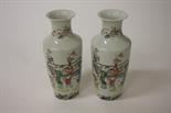 A PAIR OF FAMILLE ROSE PORCELAIN VASES, 
each with a flared neck on a tapering body, decorated