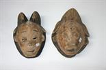 TWO CARVED AFRICAN SOFTWOOD TRIBAL MASKS, both with
fragments of original polychrome and eye