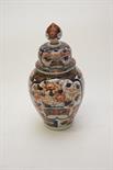 A JAPANESE IMARI VASE AND COVER, early 20th century, decorated in typical palate with panels of