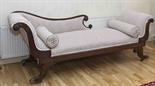 A REGENCY MAHOGANY CHAISE LONGUE
probably Irish, with two scroll ends and three-quarter padded back,