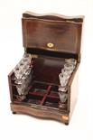 A BRASS INLAID ROSEWOOD LIQUEUR CASE
with serpentine front, the lift-up top opening to reveal a