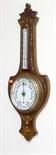 AN EDWARDIAN INLAID ROSEWOOD BANJO ANEROID BAROMETER
the shaped top above a thermometer with