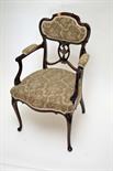 A HEAVY EDWARDIAN ROSEWOOD OCCASIONAL ARMCHAIR
with bone inlay, the back with an upward padded panel