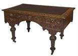 A RECTANGULAR CARVED OAK KNEEHOLE DESK,
19th century in the 17th century style, the top with a