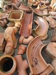 A LARGE QUANTITY OF TERRA COTTA SEWER AND WATER PIPES, underground sewer pipes, traps, and other