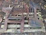 THREE HEAVY CAST IRON FIRE GRATES, together with an arched and relief-cast fire back and a bow-