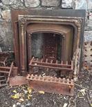 THREE HEAVY CAST IRON FIRE PLACE INSETS and a basket grate. (4)