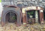 FIVE HEAVY CAST IRON FIREPLACE INSETS, 19th century, the majority with arched tops, various