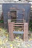A PAIR OF HEAVY CAST IRON FIREPLACE INSETS, both with door fittings and one with a single door;
