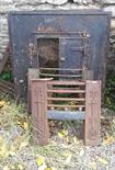 A PAIR OF HEAVY CAST IRON FIREPLACE INSETS, both with door fittings and one with a single door;