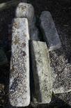 SIX CUT GRANITE SHORT POSTS and a finial, on one pallet. (7)