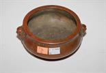 A HEAVY BRONZED IRON RED COLOURED OGEE SHAPED STONEWARE BOWL, 
with two mask handles and six-