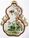 A CHINESE DOUBLE-GOURD SHAPED FAMILLE ROSE WALL PLAQUE, 
with pierced spandrels, decorated with