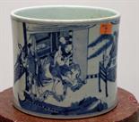 A LARGE CYLINDRICAL CHINESE BLUE AND WHITE BRUSH POT, 
decorated in two panels, one with figures