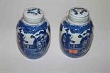 A PAIR OF CHINESE BLUE AND WHITE PORCELAIN JARS AND COVERS, 
each decorated with figures standing on