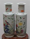 A PAIR OF CHINESE FAMILLE ROSE VASES, 
each decorated with birds, flowers and bats, 12in (30cm). (2)