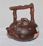 A CHINESE STONEWARE TEAPOT AND COVER, 
with rustic handles and prunus sprays, 5in (13cm). (1)